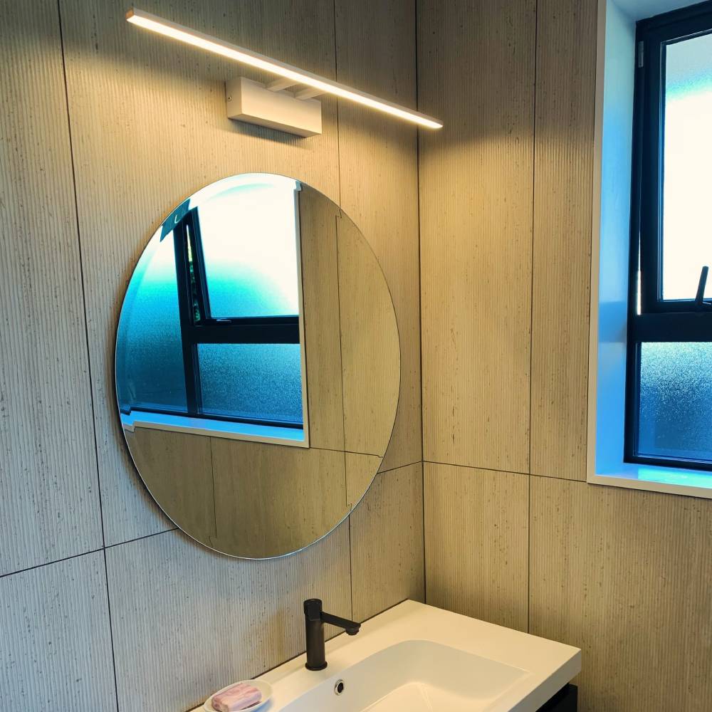 LED mirror light above round mirror in Christchurch bathroom