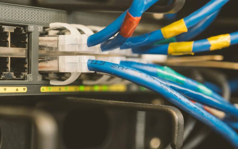 Patch cables connected to a network switch in a data cabinet - Easy Electrical Christchurch